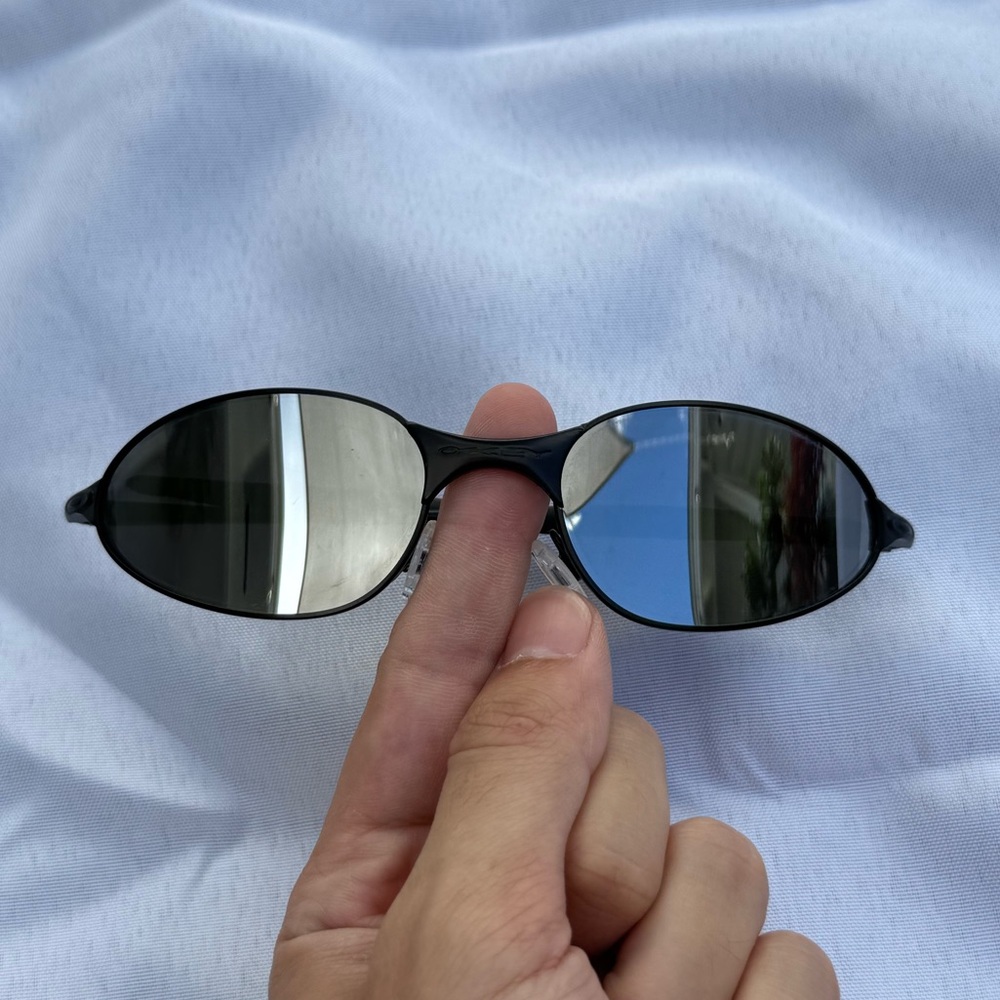 Oakley Sunglasses black metal frame with silver lenses